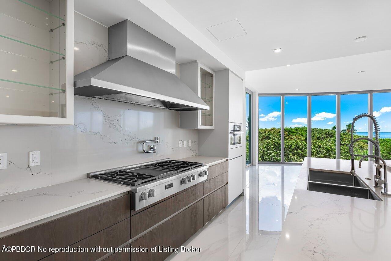 1500 South Beach Road, Unit 301 Tequesta, FL 33469 - Photo 12 of 28 a kitchen with granite countertop a stove and a sink