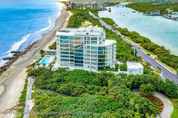 an aerial view of a residential apartment building with a yard
