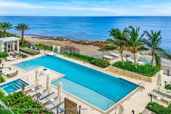 a view of a swimming pool with an outdoor seating
