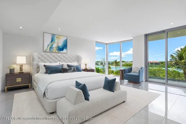 a bedroom with furniture and a large window