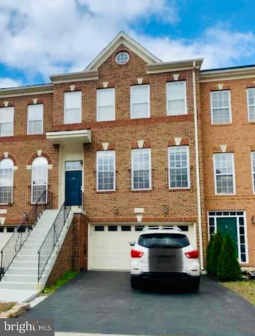a yellow building covered with tall trees