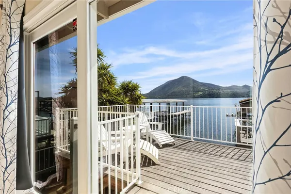a view of a balcony with wooden floor and fence