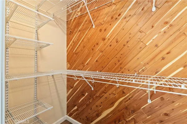 a view of a room with wooden floor and a window