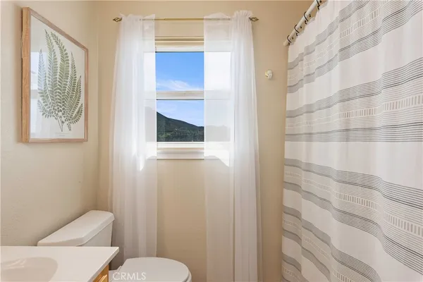 a white toilet sitting next to a bathroom sink