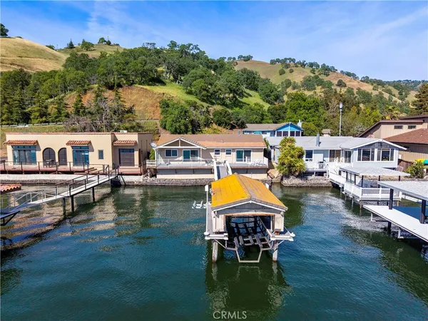 an aerial view of a house with swimming pool garden view and lake view