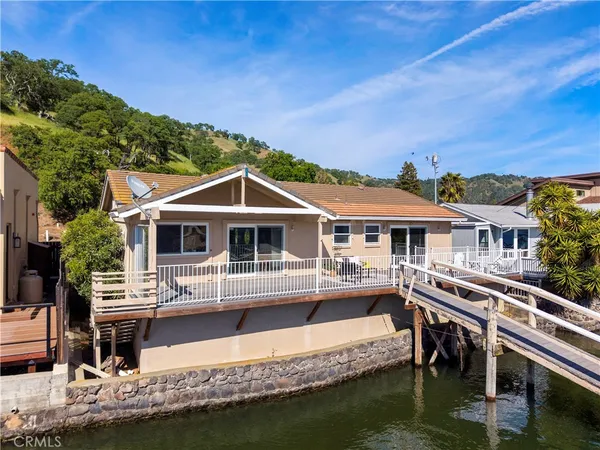 a view of a white house with a ocean view