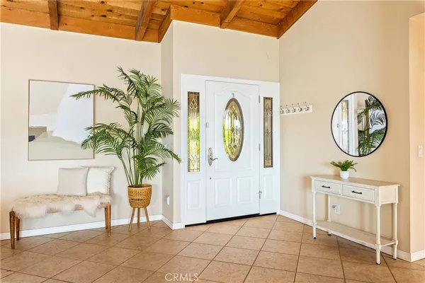a view of a entryway with kitchen and living room