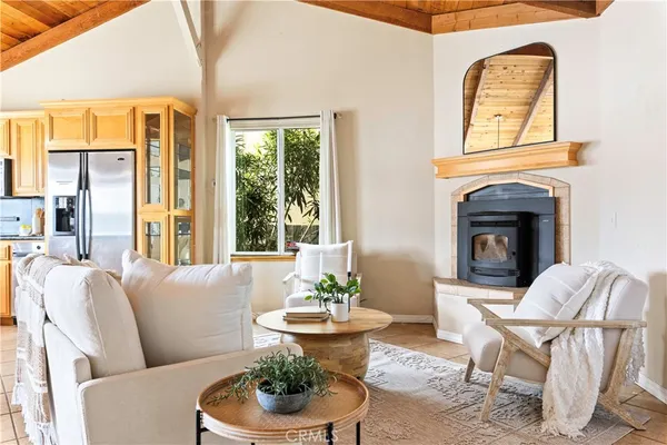 a living room with furniture fireplace and window