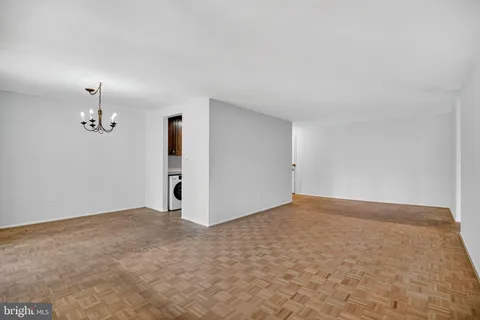 an empty room with a empty space and a chandelier fan