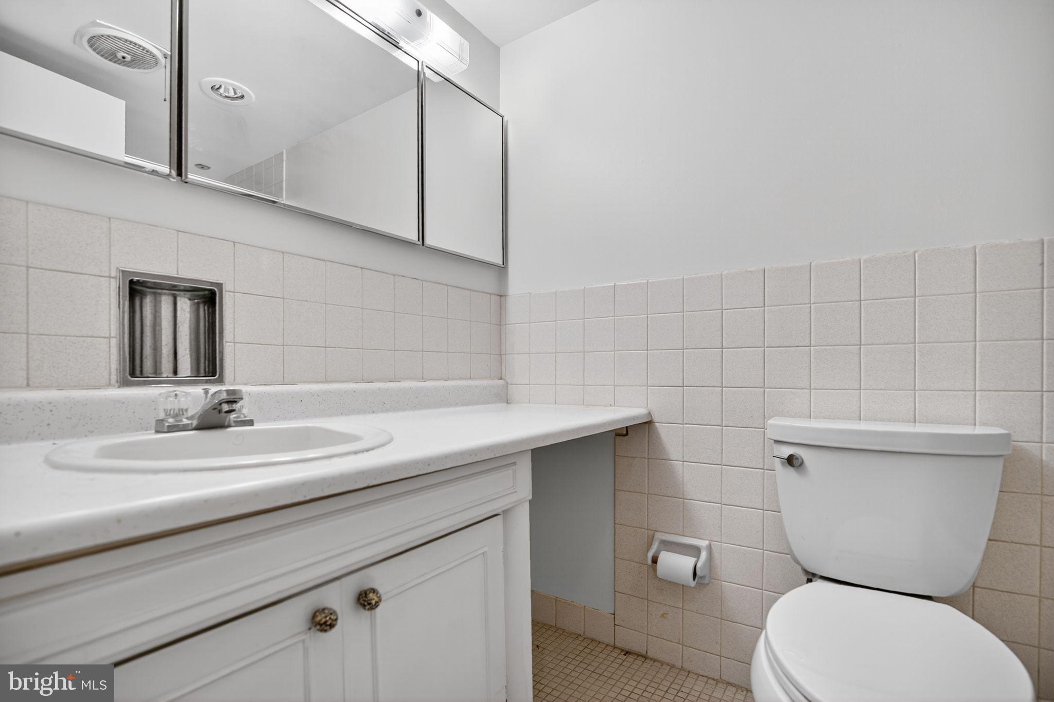 1919 Chestnut Street, Unit 2004 Philadelphia, PA 19103 - Photo 30 of 32 a bathroom with a toilet sink and mirror
