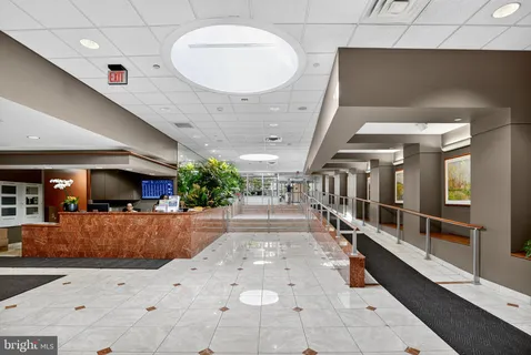 a hallway with a large mirror and entryway
