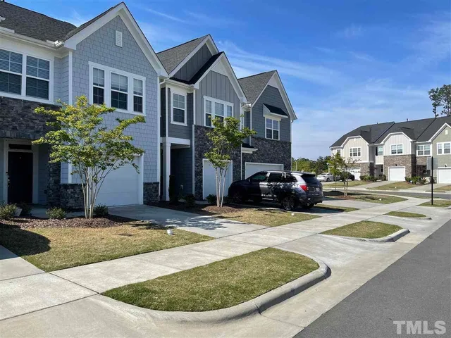 a view of multiple houses with a yard