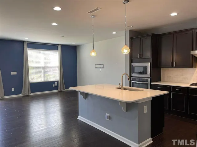 a large kitchen with wooden floor