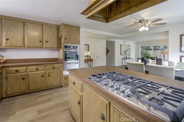 a kitchen with stainless steel appliances granite countertop a lot of counter space and wooden floors