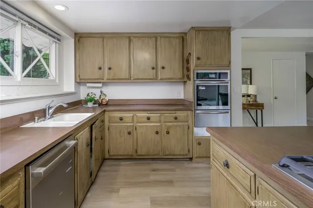 a kitchen with a sink stove and cabinets