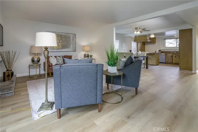 a living room with furniture a wooden floor and a fireplace