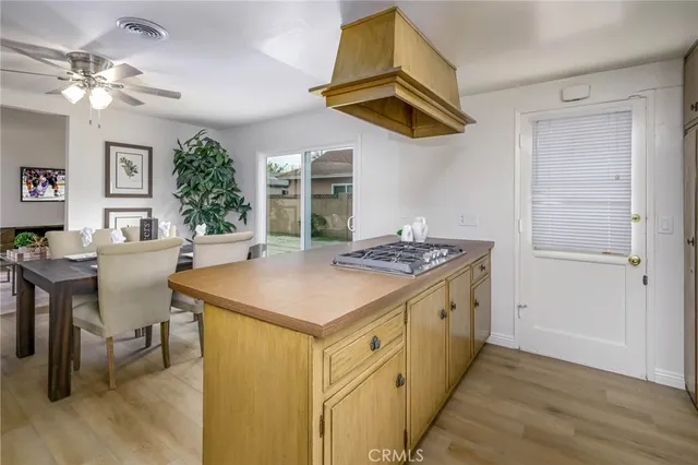 a kitchen with a stove and a dining table
