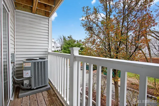 a view of a two chairs and table in the balcony