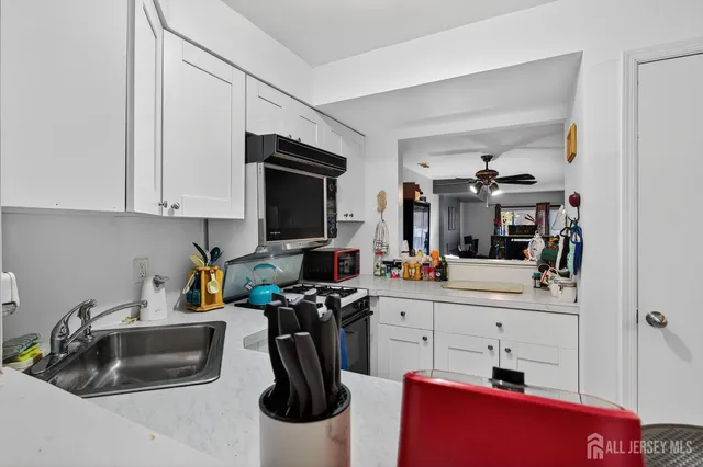 a kitchen with stainless steel appliances a stove microwave and cabinets