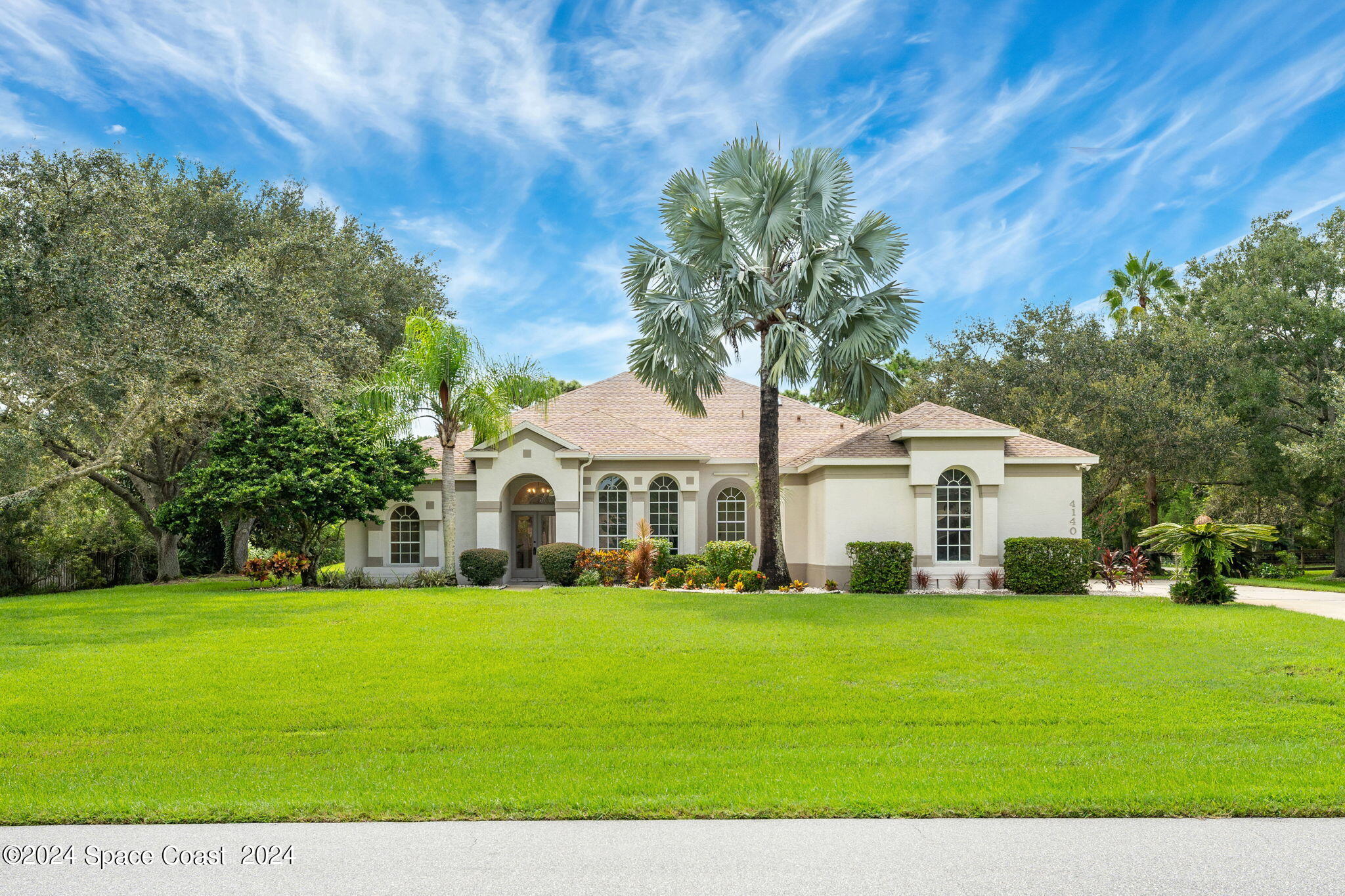 a front view of house with yard and green space