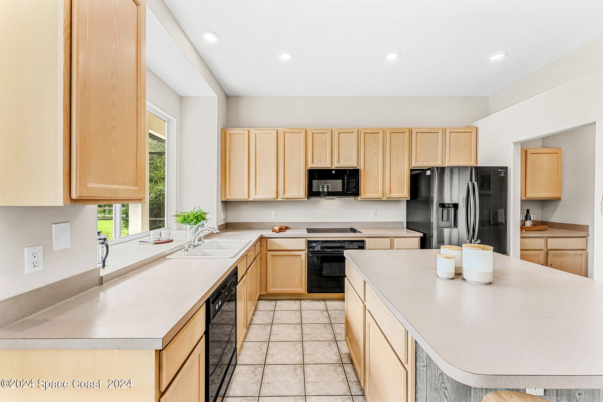 4140 Windover Way Melbourne, FL 32934 - Photo 13 of 53 a kitchen with stainless steel appliances granite countertop a sink a stove and refrigerator