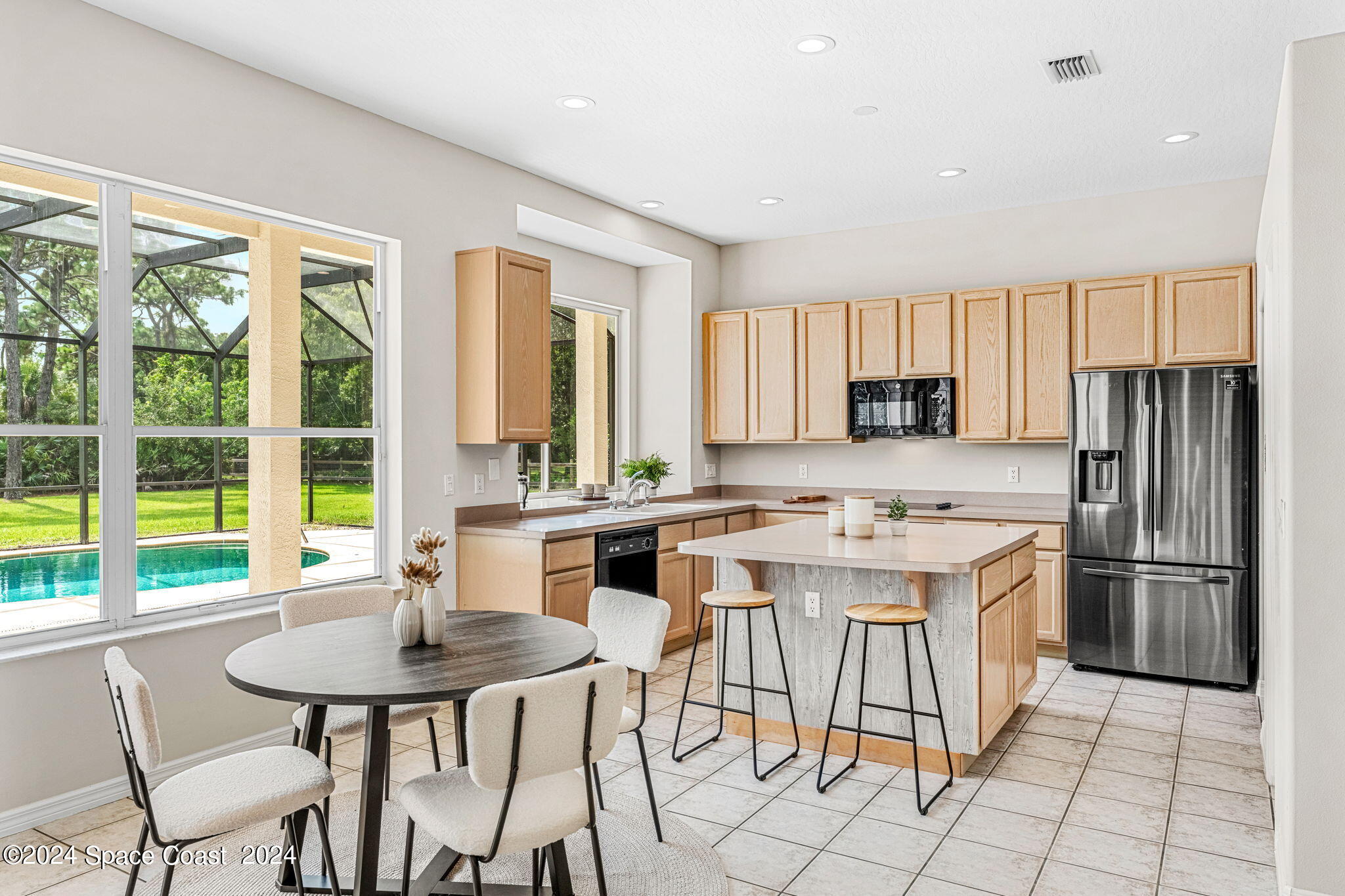 4140 Windover Way Melbourne, FL 32934 - Photo 14 of 53 a kitchen with stainless steel appliances granite countertop a stove a refrigerator a kitchen island a table and chairs in it