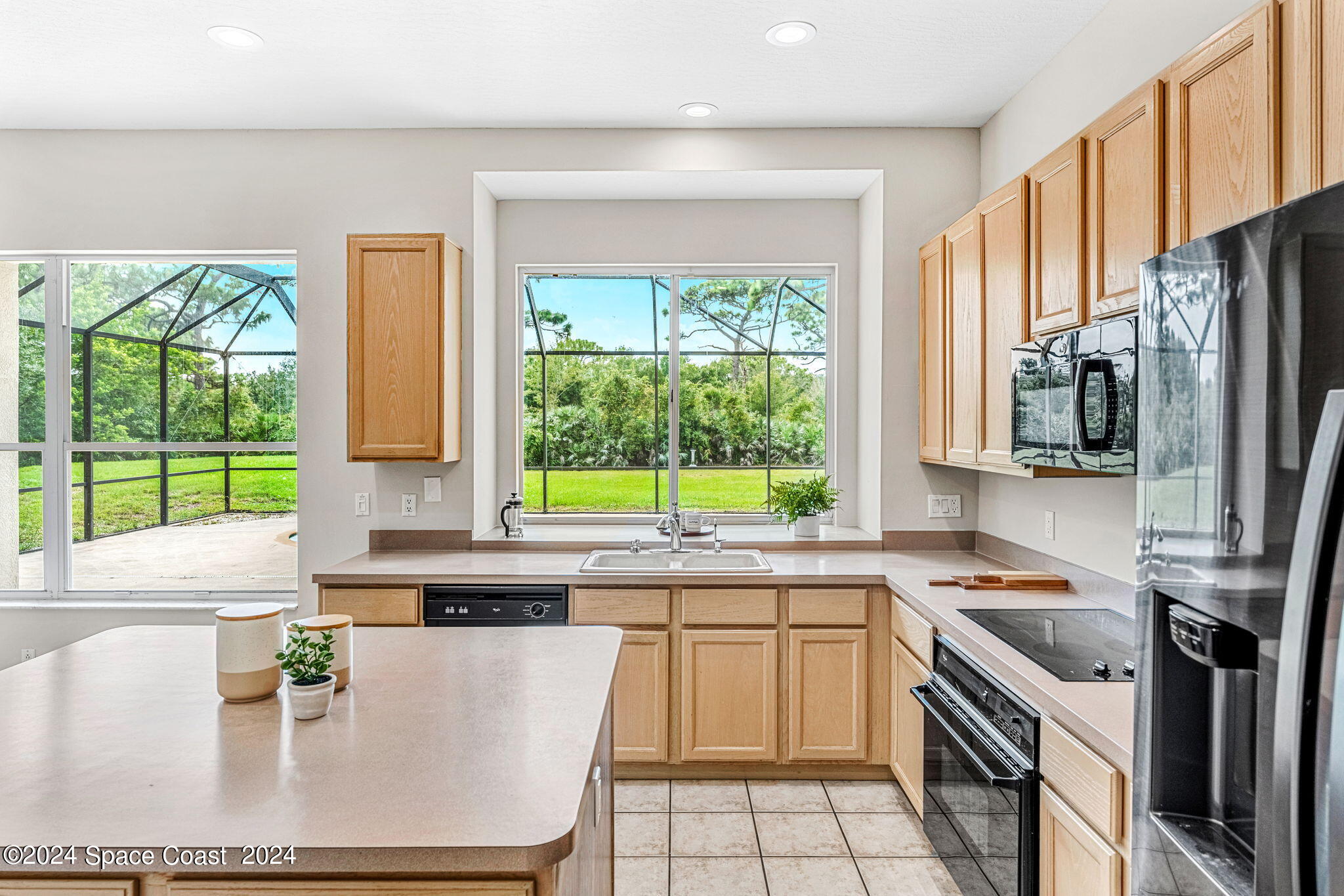 4140 Windover Way Melbourne, FL 32934 - Photo 15 of 53 a kitchen with stainless steel appliances granite countertop a stove a sink and a microwave