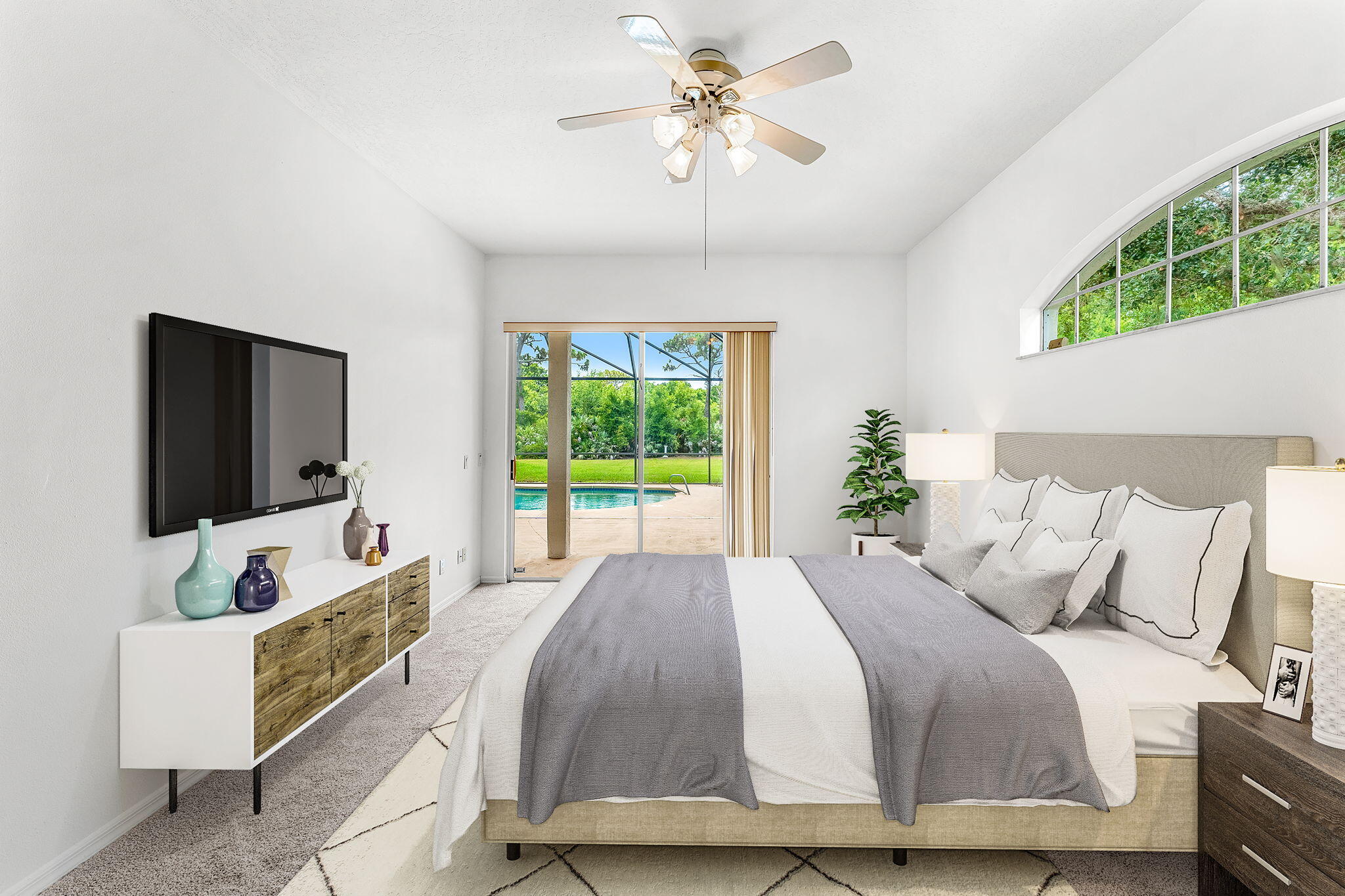 4140 Windover Way Melbourne, FL 32934 - Photo 18 of 53 a spacious bedroom with a bed and a flat screen tv