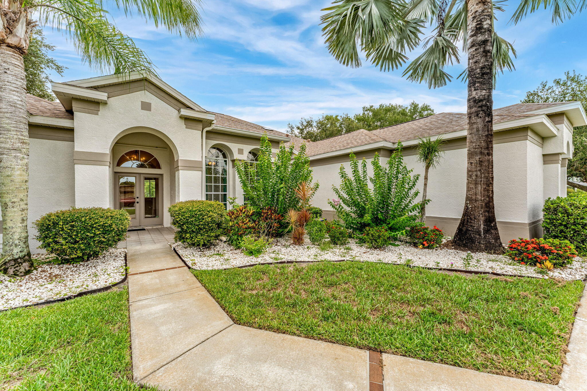 4140 Windover Way Melbourne, FL 32934 - Photo 2 of 53 a front view of a house with a garden