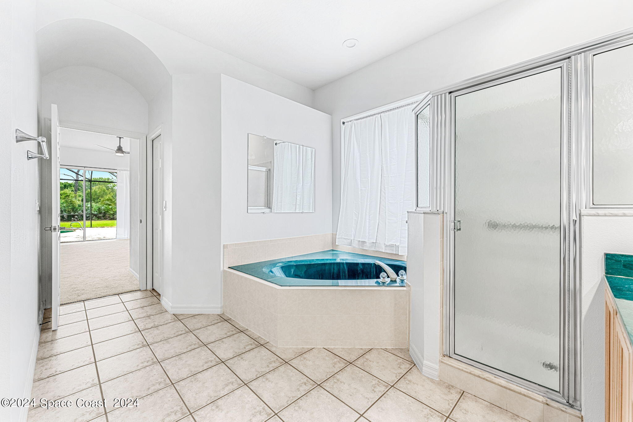 4140 Windover Way Melbourne, FL 32934 - Photo 21 of 53 a view of a room that has a wooden floor and a shower