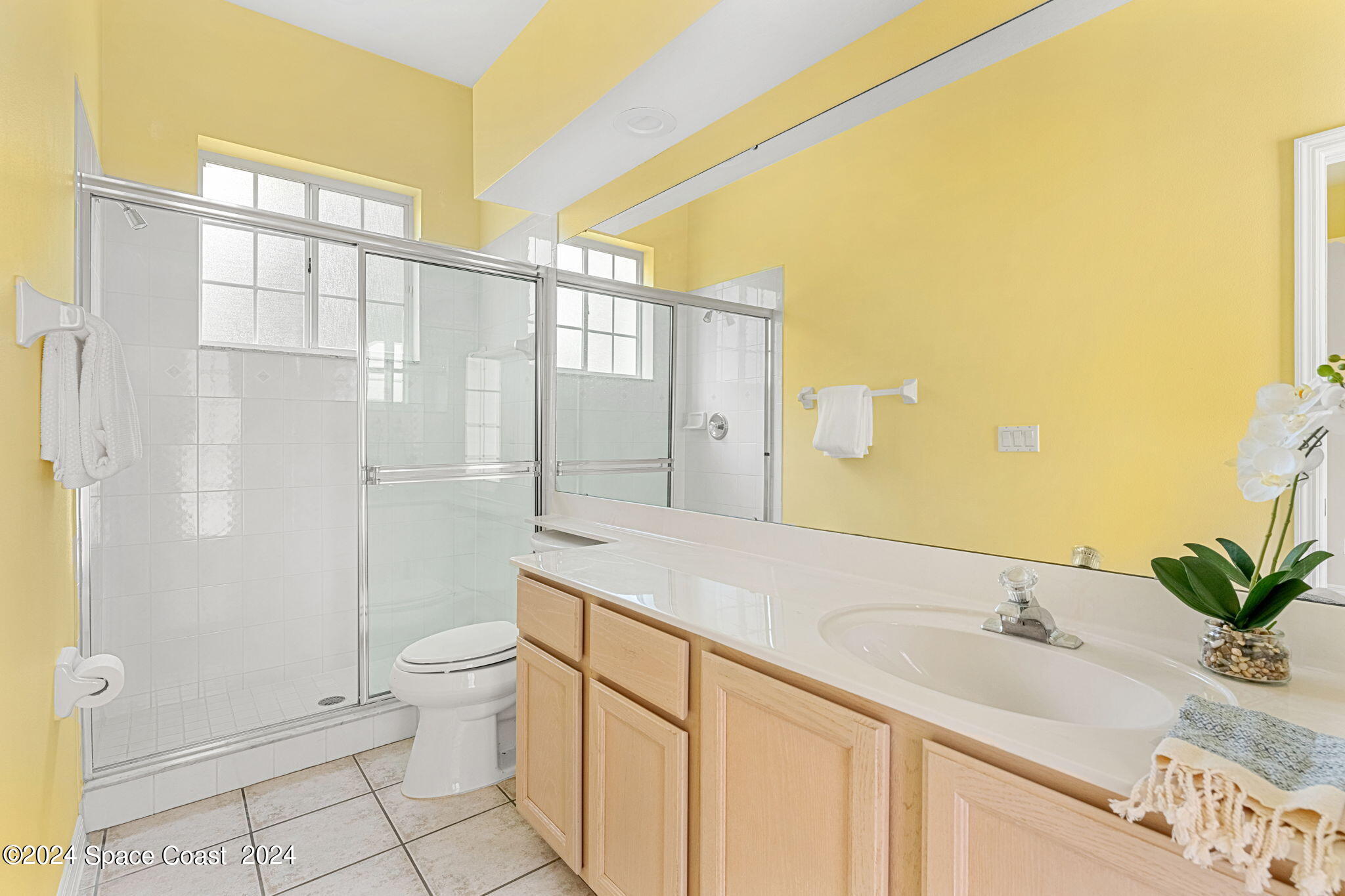 4140 Windover Way Melbourne, FL 32934 - Photo 24 of 53 a bathroom with a granite countertop sink a toilet and shower