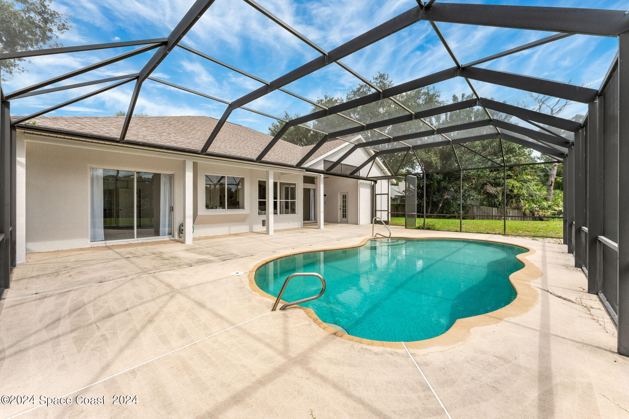 4140 Windover Way Melbourne, FL 32934 - Photo 31 of 53 a view of a swimming pools under an umbrella
