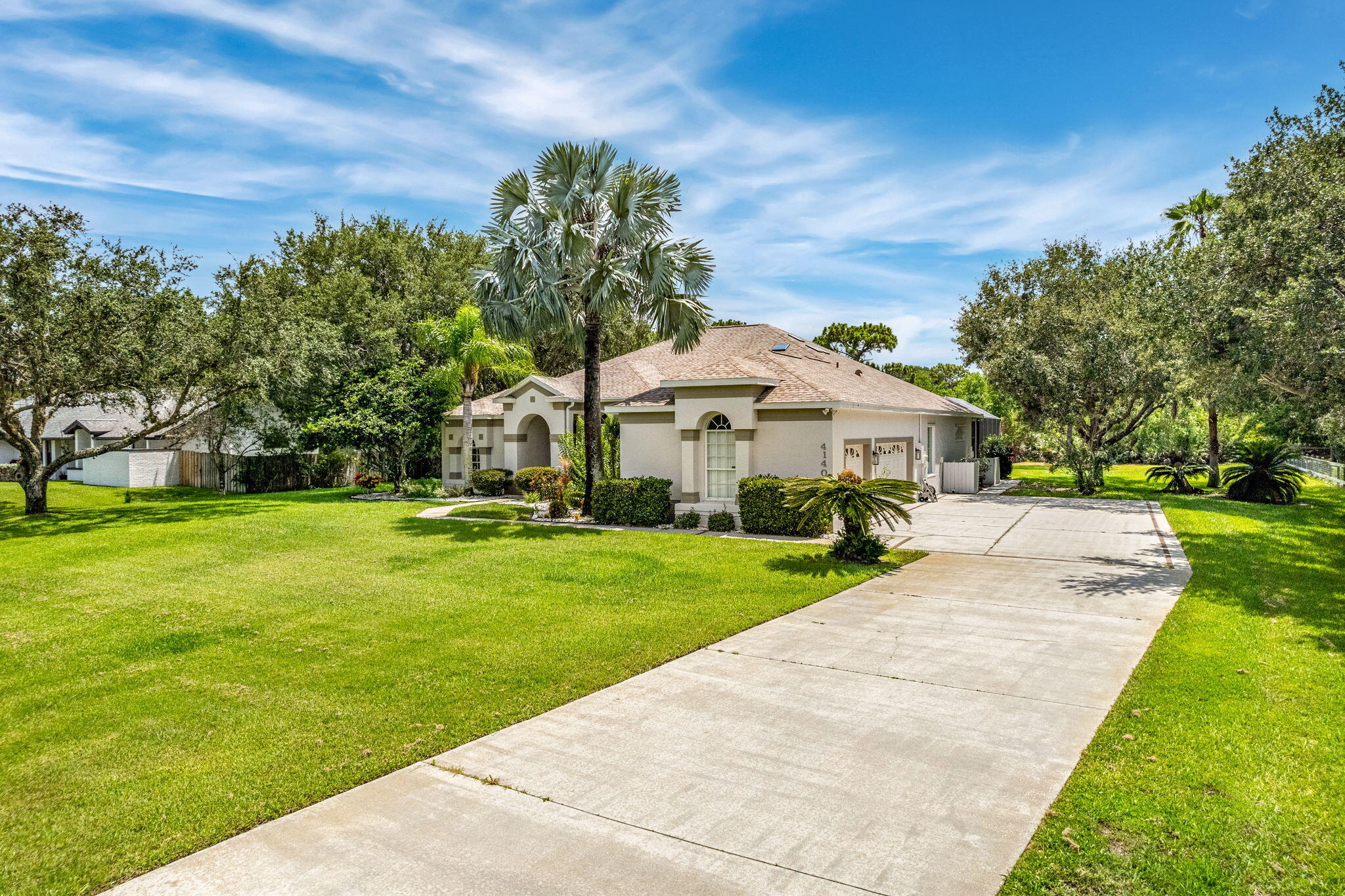 4140 Windover Way Melbourne, FL 32934 - Photo 40 of 53 a front view of a house with garden and trees
