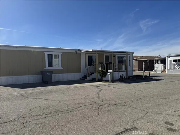 a backyard of a house with yard and outdoor seating