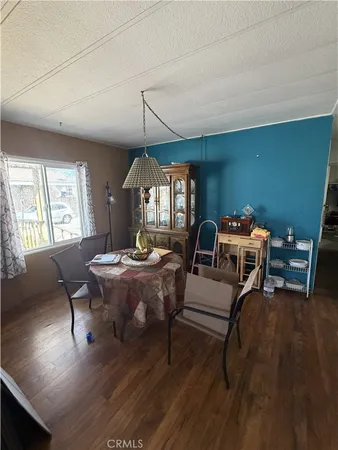a living room with furniture a window and wooden floor