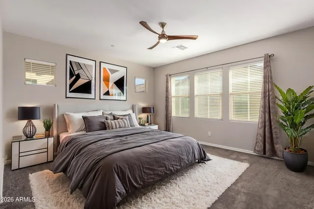 a bedroom with a large bed and a window