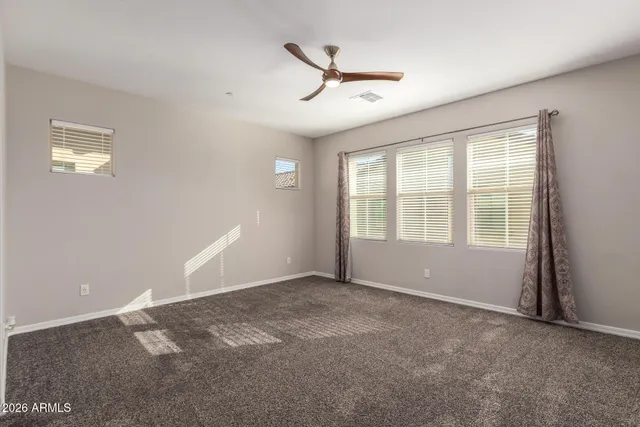 a view of a livingroom with a ceiling fan and window