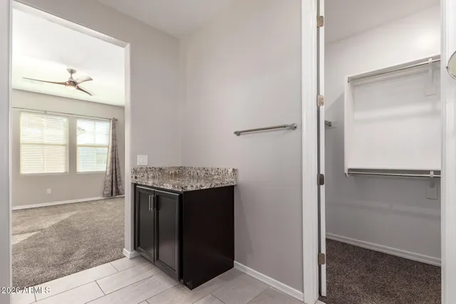 an empty room with cabinet and windows