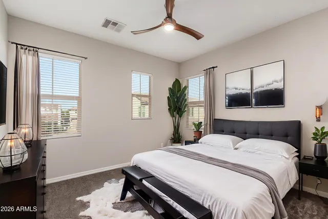 a bedroom with a large bed and a chandelier