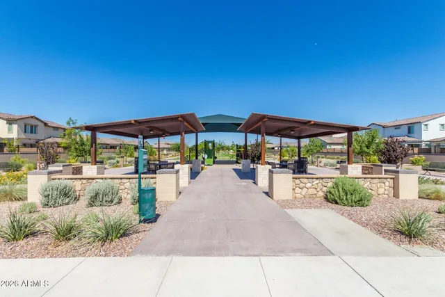 a view of a patio with a table and chairs under an umbrella