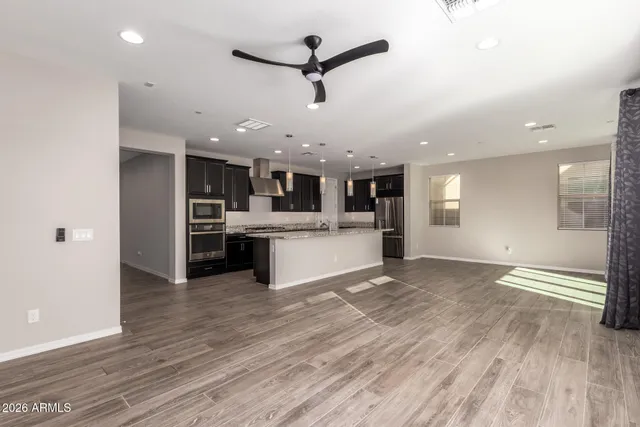 a view of kitchen with refrigerator and microwave