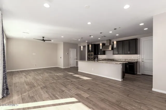 a view of kitchen with kitchen island and stainless steel appliances