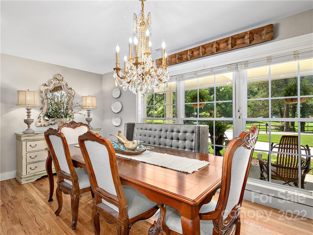 1 Inglewood Road Asheville, NC 28804 - Photo 11 of 40 a view of a dining room with furniture a chandelier and wooden floor