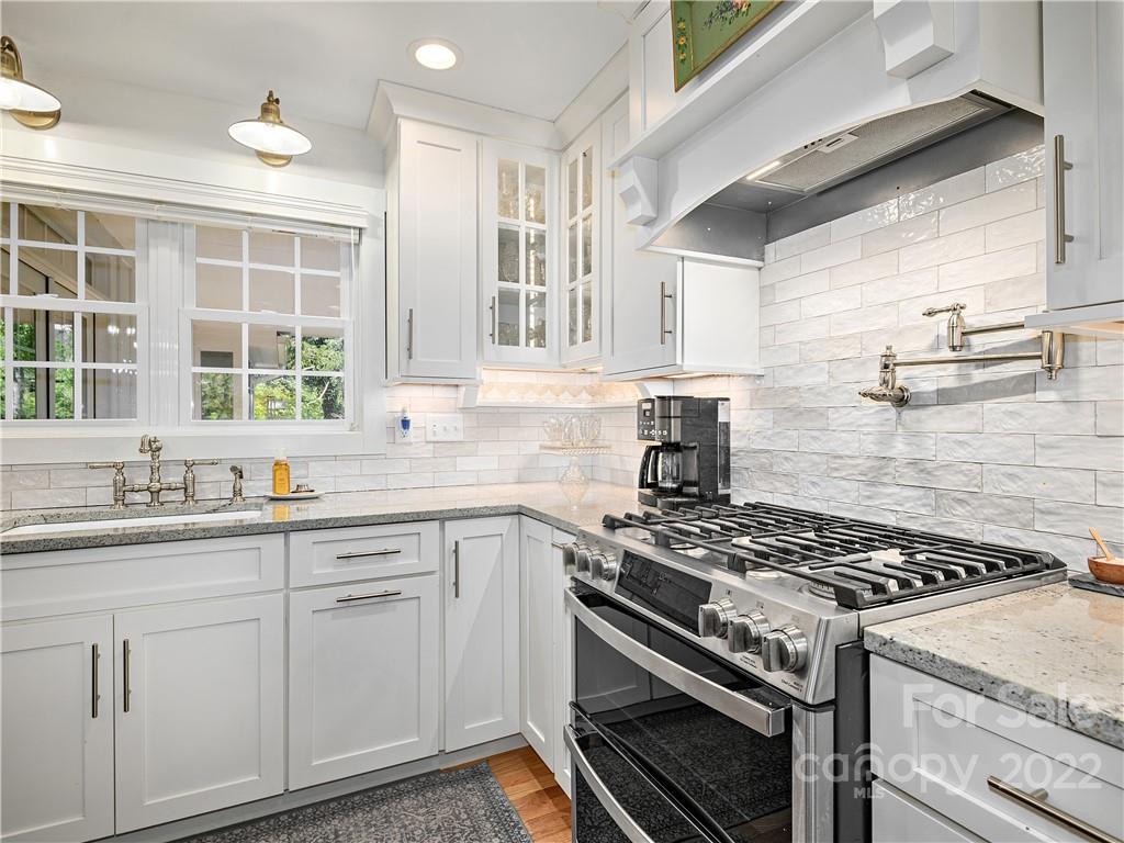 1 Inglewood Road Asheville, NC 28804 - Photo 14 of 40 a kitchen with cabinets appliances a sink and a window