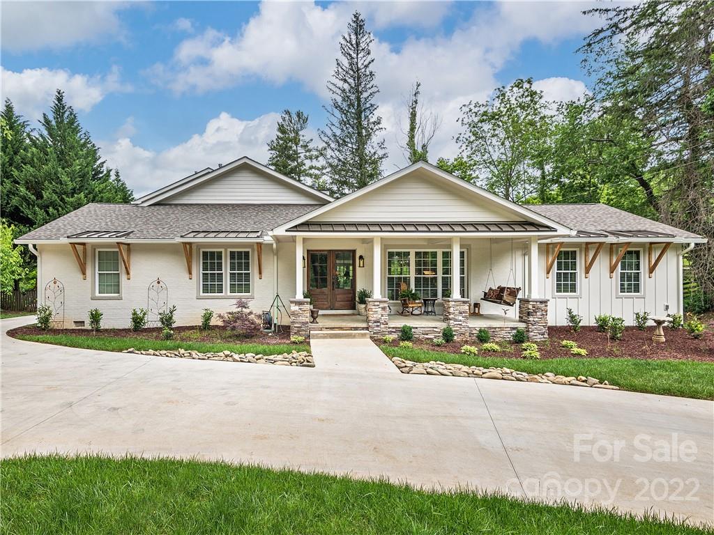 1 Inglewood Road Asheville, NC 28804 - Photo 2 of 40 a front view of a house with a garden and sitting area