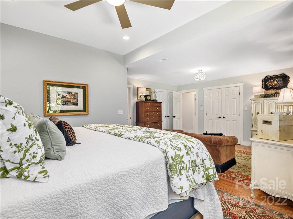 1 Inglewood Road Asheville, NC 28804 - Photo 21 of 40 a bedroom with a bed and a cabinets