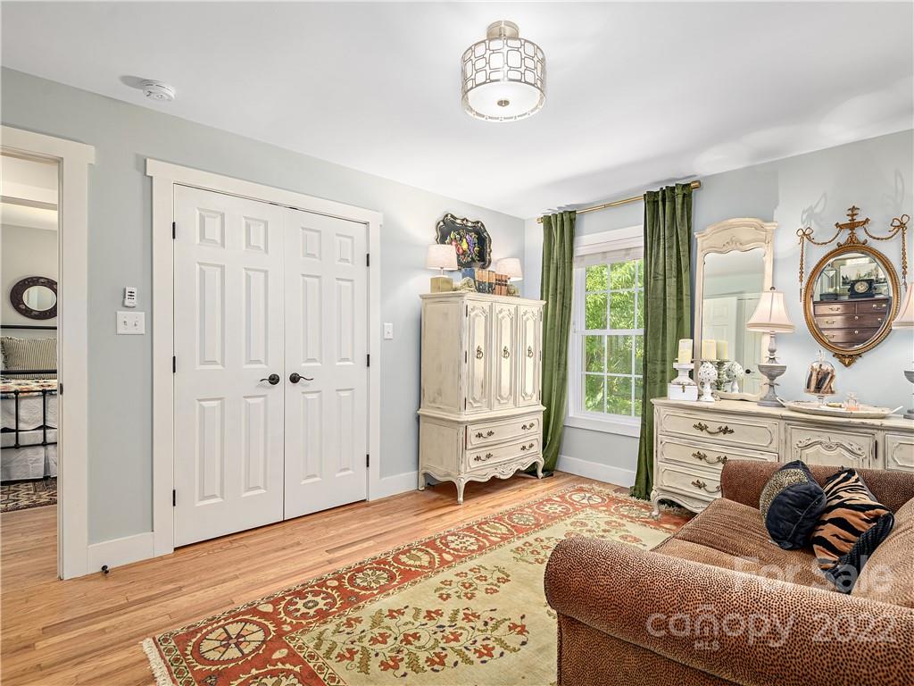 1 Inglewood Road Asheville, NC 28804 - Photo 22 of 40 a bedroom with a bed and wooden floor