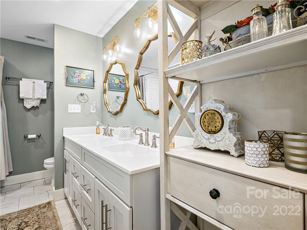 1 Inglewood Road Asheville, NC 28804 - Photo 23 of 40 a bathroom with a sink and a mirror