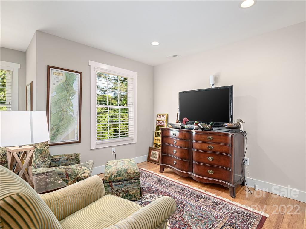 1 Inglewood Road Asheville, NC 28804 - Photo 25 of 40 a living room with furniture and a flat screen tv