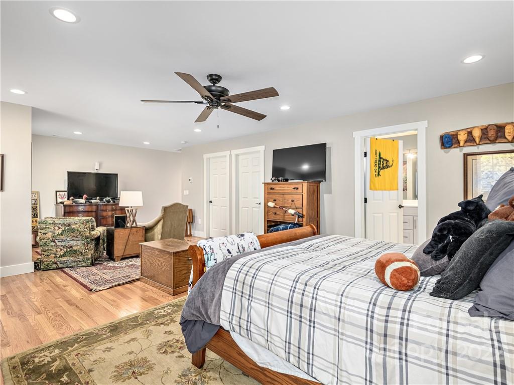 1 Inglewood Road Asheville, NC 28804 - Photo 26 of 40 a bedroom with a bed and a flat screen tv